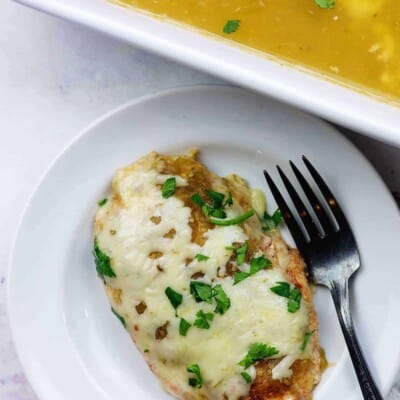 cheesy salsa verde chicken on white plate