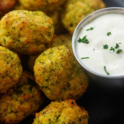 cheesy broccoli tots piled next to ranch dressing.