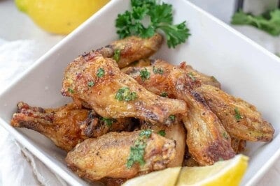air fryer lemon pepper wings in white bowl.